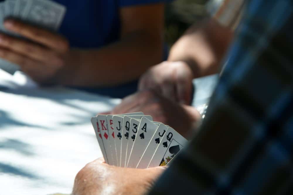 Holding playing cards in one hand. Printing values at the four corners makes it easy to browse. 