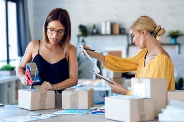 two busy women in studio preparing packages to be sent
