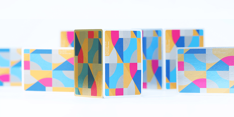 several multicolored playing cards standing up
