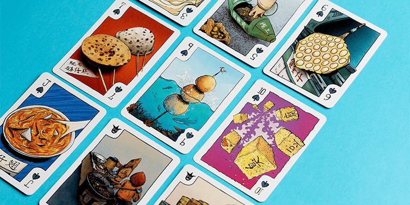 custom playing cards arranged on a tabletop with unique designs