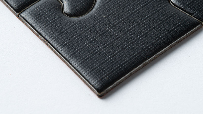 black puzzle piece with linen design