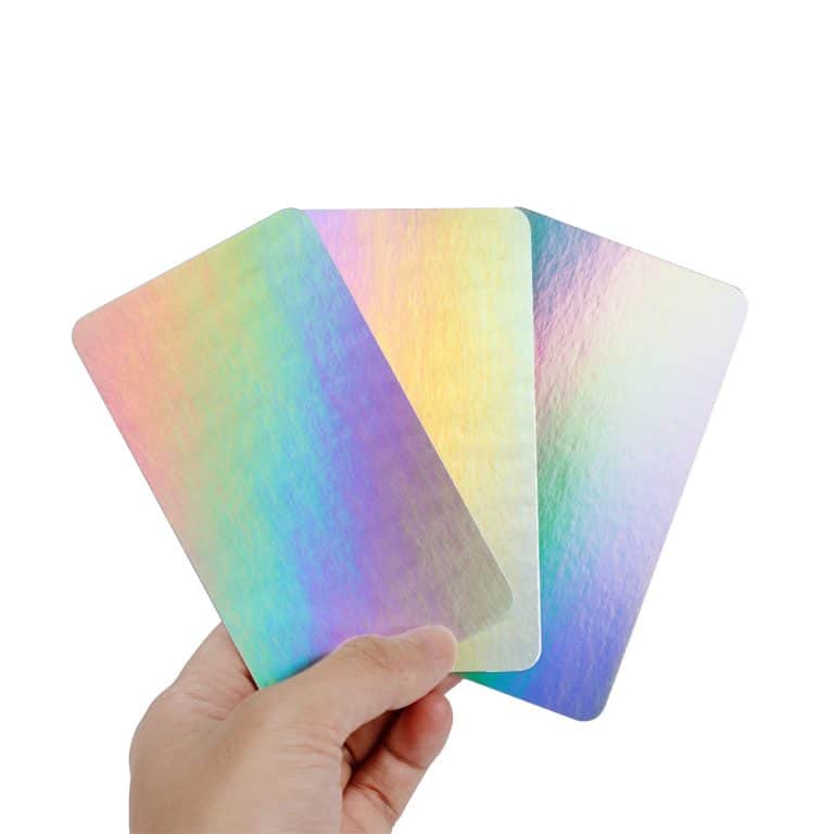 A hand holding 3 holographic cards