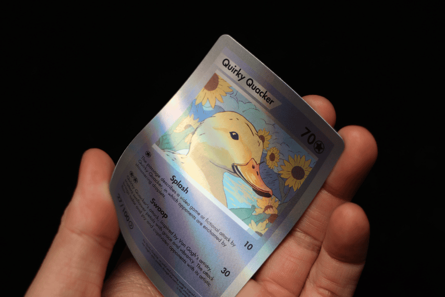 A hand holding a duck design holographic Trading Card Sample
