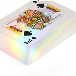 stack of playing cards with holographic edges and the king of spades on top