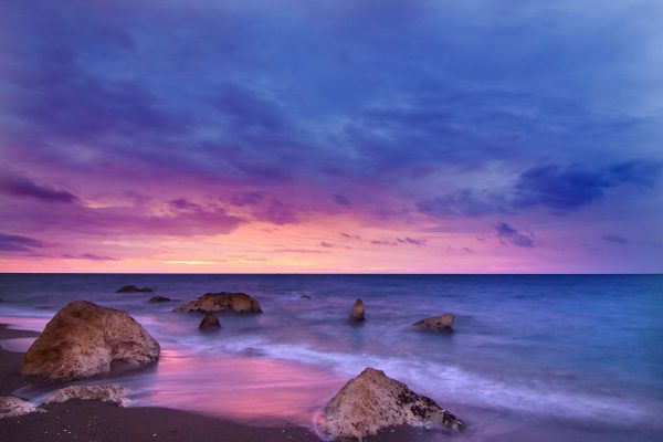 sunset view on a beach with clouds above
