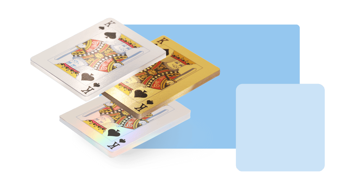three playing cards with different colored edges and finishes