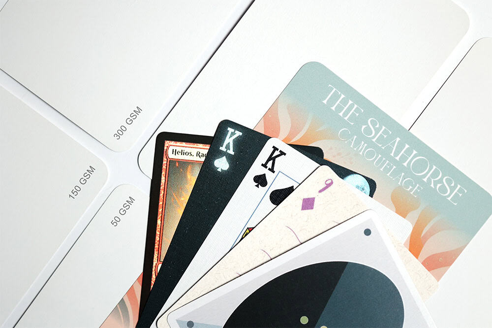 fanned out custom card decks with card stock laid out behind