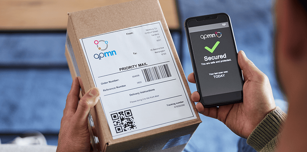 hands holding a delivery package and a mobile phone