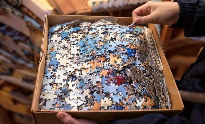 box filled with loose jigsaw puzzle pieces