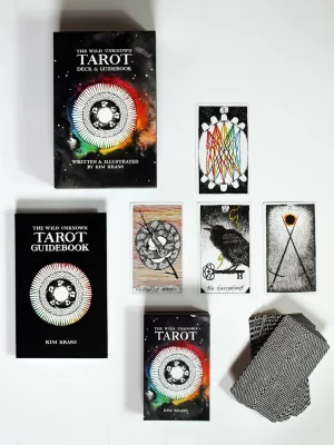 Several tarot card decks laid flat on white surface