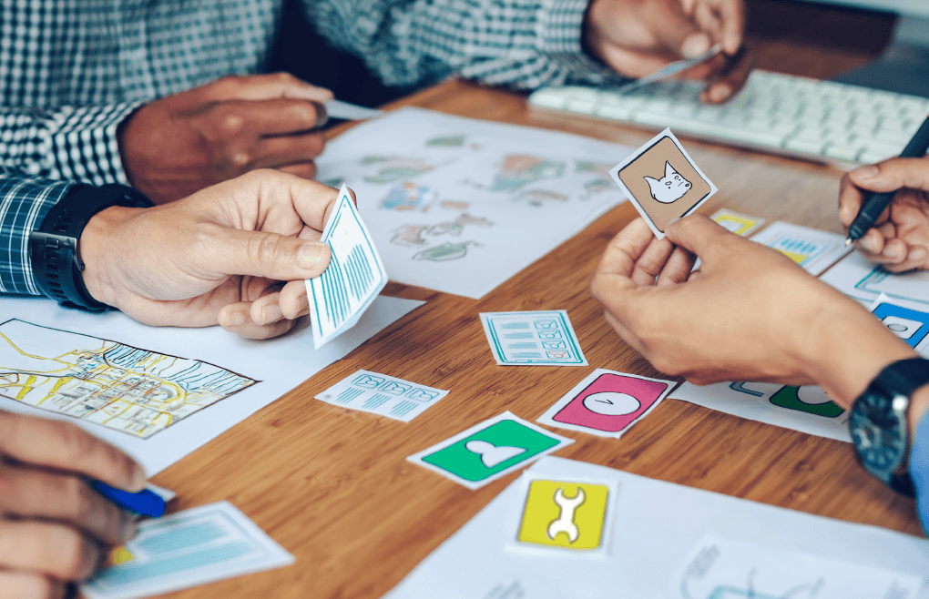 people deciding on a game mechanics around a table