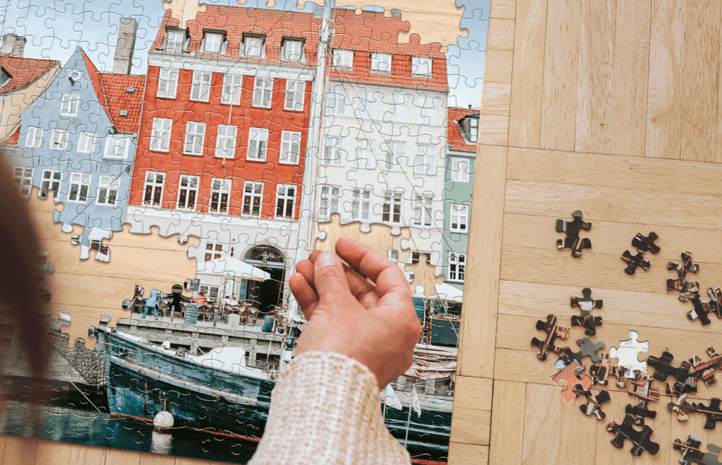 overhead view of a man playing a jigsaw puzzle