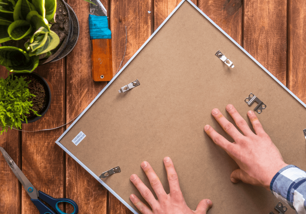 back of a puzzle board with hands holding it up