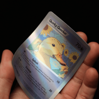 A hand holding a duck design holographic Trading Card Sample